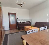 Living room in a 3-room apartment with wooden decor and simple furniture.