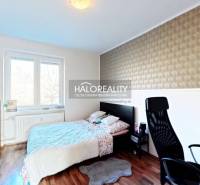 Bedroom with a bed, desk, and wooden decor flooring in a 3-room apartment.