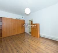 A room with a wooden floor and a large wardrobe in a five or more room apartment.