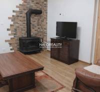 Living room in a family house with a fireplace and wooden decor flooring.