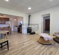 Living room in a family house with a wooden decor floor, fireplace, and furniture.
