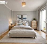 A bedroom with a comfortable bed, an armchair, and a wooden decor floor in a family house.