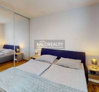 Bedroom with a double bed and a mirrored built-in wardrobe in a 2-room apartment.