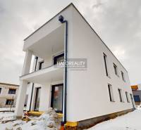 Office building in Poprad during winter, with a simple white facade, without people.