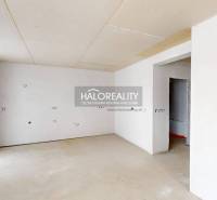 A spacious office with white walls and a large window.