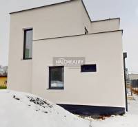 An office building in Poprad with a modern facade, covered in snow.