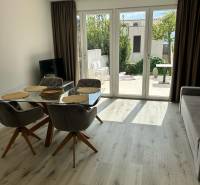 Recreational apartment with glass doors and wooden decor flooring.