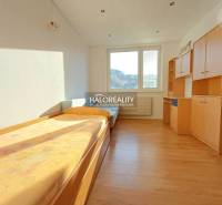 A room in a 3-room apartment with a bed and wardrobes, floor with wood decor.
