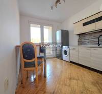 A kitchen in a 3-room apartment with a wooden decor floor and equipment.