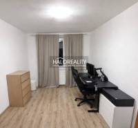 A study in a 3-room apartment, with a wooden decor floor, a desk, and drawers.