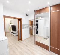 Interior of a 3-room apartment with a wooden decor floor and a built-in wardrobe.