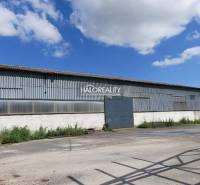 Warehouses and halls in Hurbanova Ves with steel structures under the blue sky.