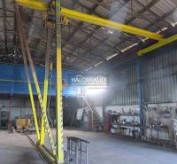 Industrial hall interior with a crane and work tools in warehouses and halls.
