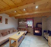 Cozy interior of a cabin with a fireplace and wood-patterned flooring.