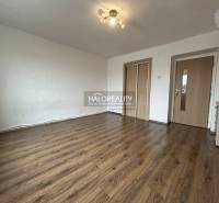 A bright interior in a 2-room apartment with wood-patterned flooring and white walls.