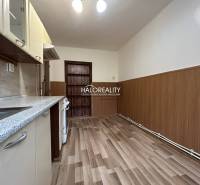 A kitchen with a wooden decor floor in a 2-room apartment.