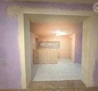 The interior of a family house with tiled flooring and purple walls.