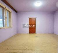 A room in a family house with purple walls and a wooden decor floor.