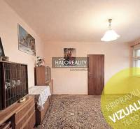 Interior in a family house with furniture, carpet, and paintings on the walls.
