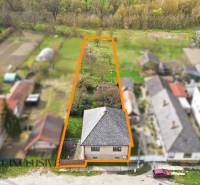 A family house in Malá nad Hronom with an extensive plot, surrounded by neighboring buildings.