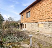 A family house in Malá nad Hronom, brick facade, covered with ivy, rustic character.