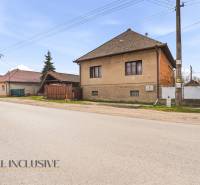 A family house in Malá nad Hronom with a brown facade and electric poles.