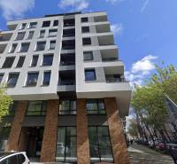 A five-story building on Bernolákova Street in Bratislava - Staré Mesto surrounded by trees.