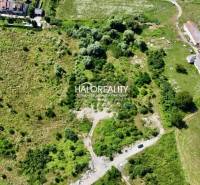 Aerial view of land - housing in Tornaľa with greenery and buildings in the surroundings.