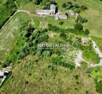 An aerial view of residential plots in Tornaľa surrounded by greenery.