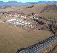 Aerial view of residential plots in Gôtovany with a mountain panorama on the horizon.