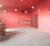 Empty, red commercial spaces with chairs and floor tiles, five light fixtures visible.