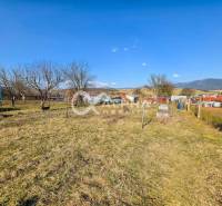 A garden at a family house in Spišské Vlachy with a view of the surrounding countryside and mountains.