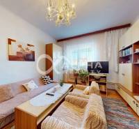 Living room in a family house with a sofa, coffee table, chandelier, and furniture set.