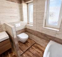 Bathroom with toilet and floor with wood decor in a 2-room apartment.