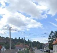 A view of a street with family houses in Levice suitable for residential land.