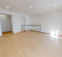 A room with a wooden floor decor in a two-room apartment. Light through a large window.