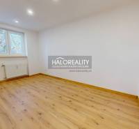 An empty room with a wooden decor floor in a two-room apartment, bright space.