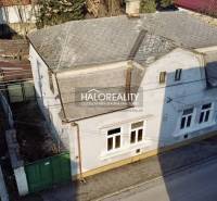 A family house in Rimavská Sobota with a white facade and a pitched roof.