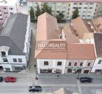 Commercial premises in Rimavská Sobota with historic buildings and cars on the street.