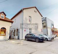 Commercial premises in Rimavská Sobota with parked cars and an access road.