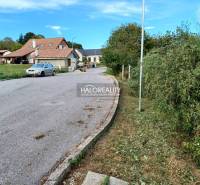 A family house in the village of Terany, surrounded by gardens and a paved road.