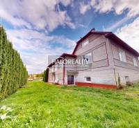 A family house in Hrachovo with a well-maintained lawn and a hedge.