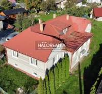 A family house in Hrachovo with a garden and a red metal roof.