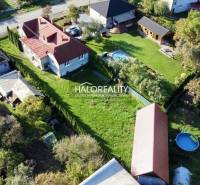 Aerial view of family houses in Hrachovo with spacious gardens and a swimming pool.