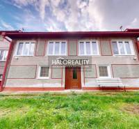 A family house in Hrachovo with a nice green lawn and white shutters.