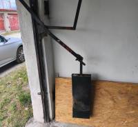 The interior of the garage with a wooden decor, detail on the door mechanism.