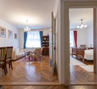 Living room and bedroom in a 3-room apartment with a wooden decor floor.