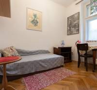 A room in a 3-bedroom apartment with decorative flooring, chairs, and a table.