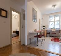 A kitchen with dining area, access to a room, and a floor with a wooden decor in a 3-room apartment.