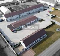 Aerial view of commercial premises with parking lot in an industrial area.